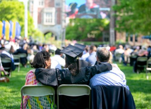 A 2021 Trinity College Graduate sitting with family