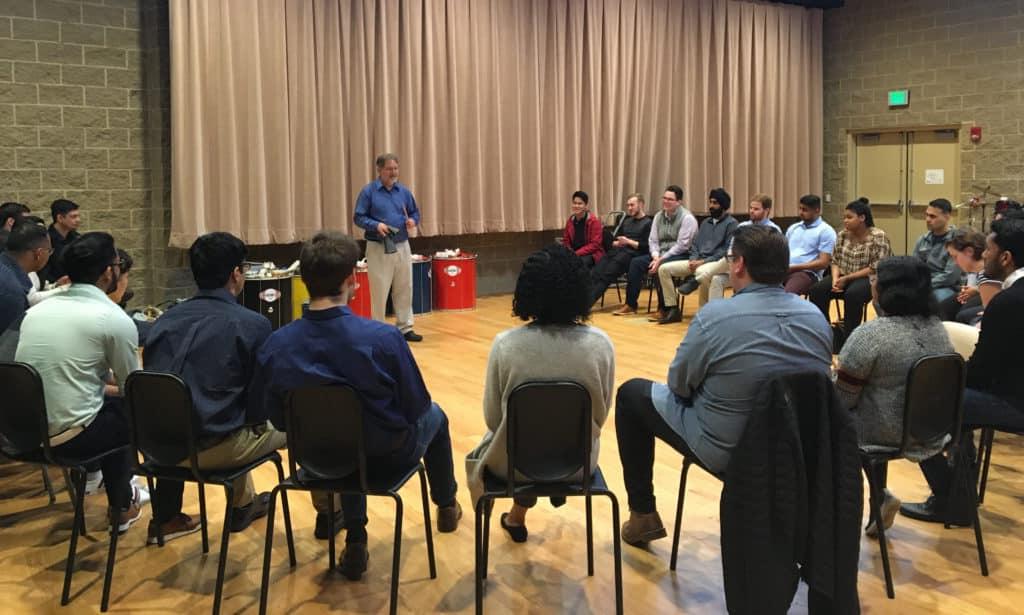 Trinity Associate Professor of Music Eric Galm instructs an Infosys training group on active listening in Trinity’s Gruss Music Center. 